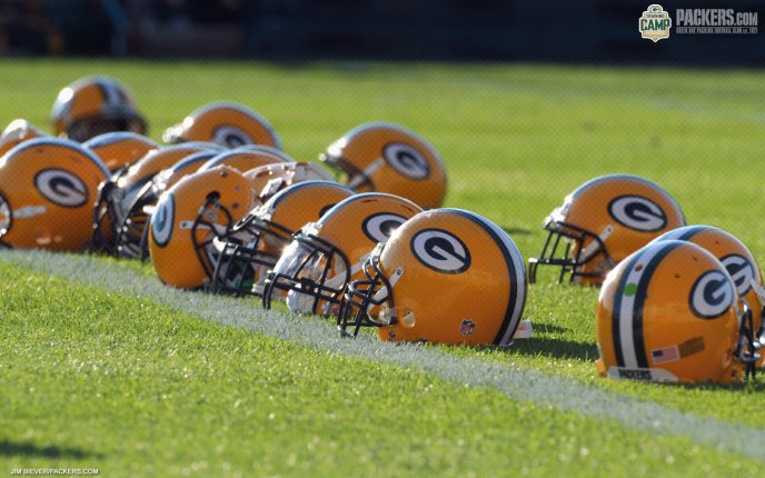 Many orange helmets on the football field