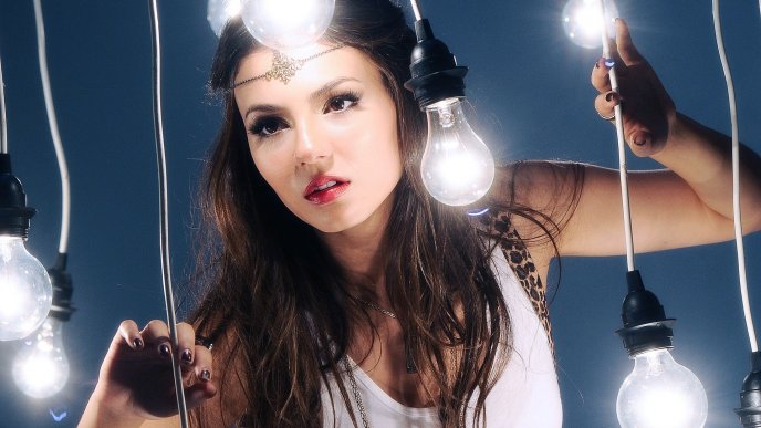 Victoria Dawn Justice poses between many bulbs