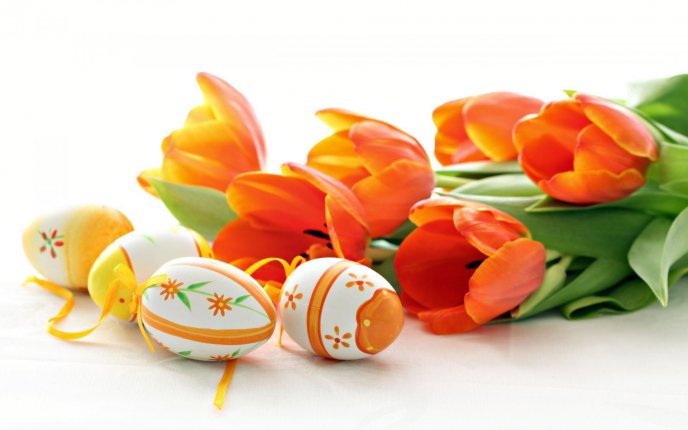 Wonderful Orange Easter eggs and red tulips - Happy Holiday