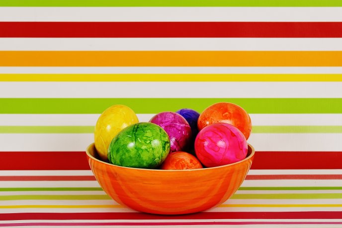 Easter eggs in a basket - Colorful background