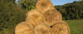 Bales of hay sit in a triangle HD wallpaper