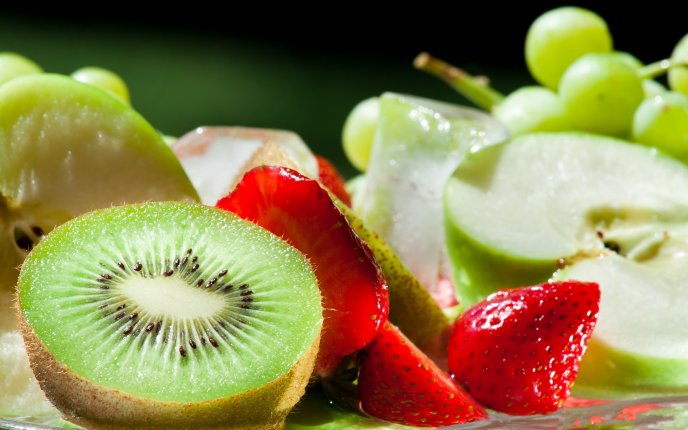 Delicious fruits - kiwi, strawberries, apple and grapes