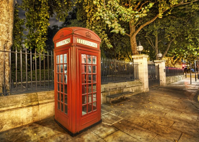 Red telephone booth on the sidewalk in London HD wallpaper