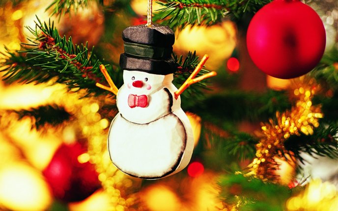 Christmas ornament shaped snowman hanging in the tree