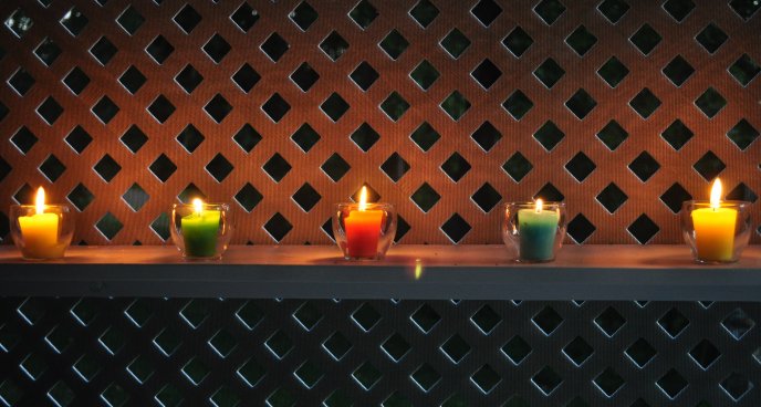 Colored candle in the garden - hot summer night