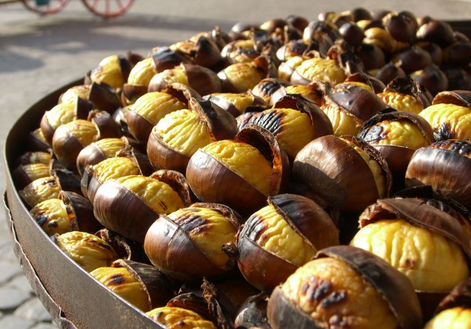 A pan full of roasted chestnuts - autumn fruits