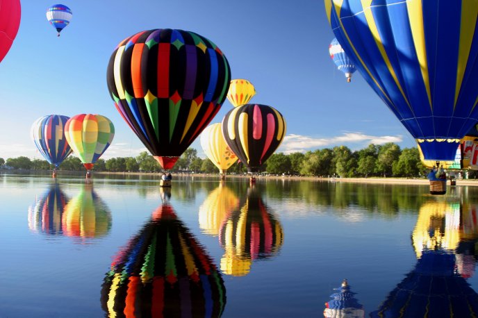 Colored hot air balloons over the lake