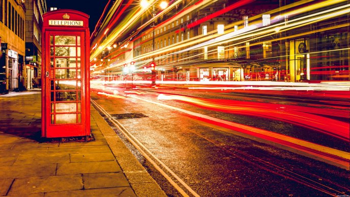 Red telephone cabine in the middle of London - Night lights