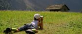 Child looking through binoculars at the nature