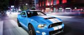 Shiny blue Mustang Shelby GT500 run in the city