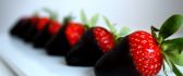 Red strawberries with dark chocolate - delicious dessert