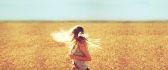 Girl with beautiful blonde hair in the golden wheat field