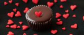 Small red hearts on a sweet chocolate muffin - HD food time